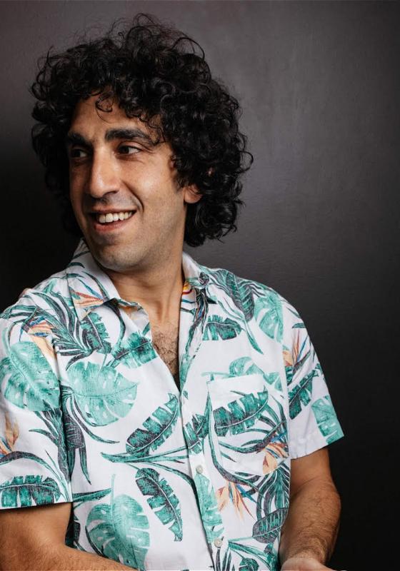Ray smiling wearing a Hawaiian printed shirt