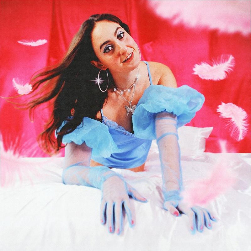 Catherine posed on a bed in a light blue dress & gloves. 