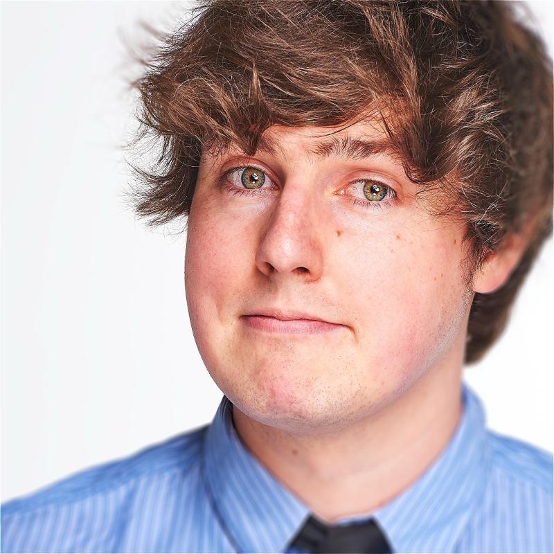 A man wearing a blue shirt and tie.