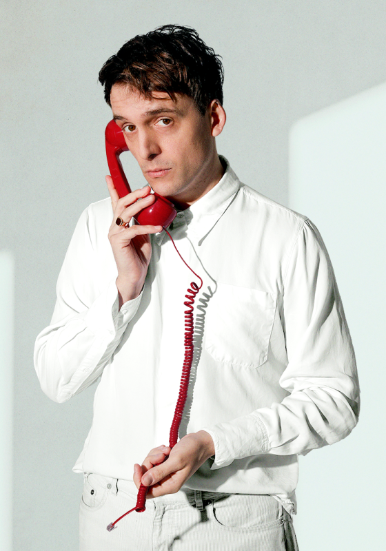 Graham holding a disconnected red telephone