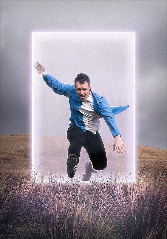 A person in a casual outfit mid-jump across a glowing portal in a grassy field.