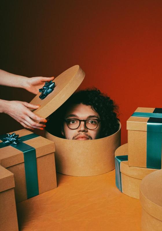 A person in a gift box with a lid open