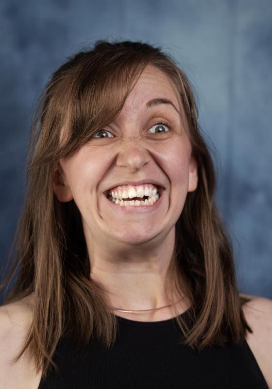 A person smiling with her mouth open