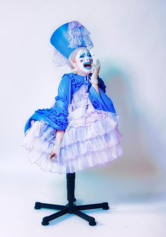 Image of Cabbage The Clown, performer, sitting atop a chair