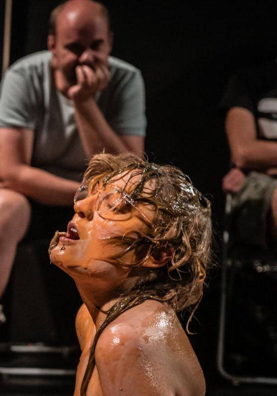 Image of Rosa Garland, performer, performing in front of three audience members