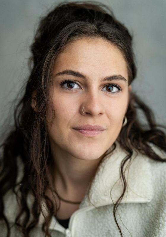 Image of Rosalie Minnitt, performer, in front of a grey background