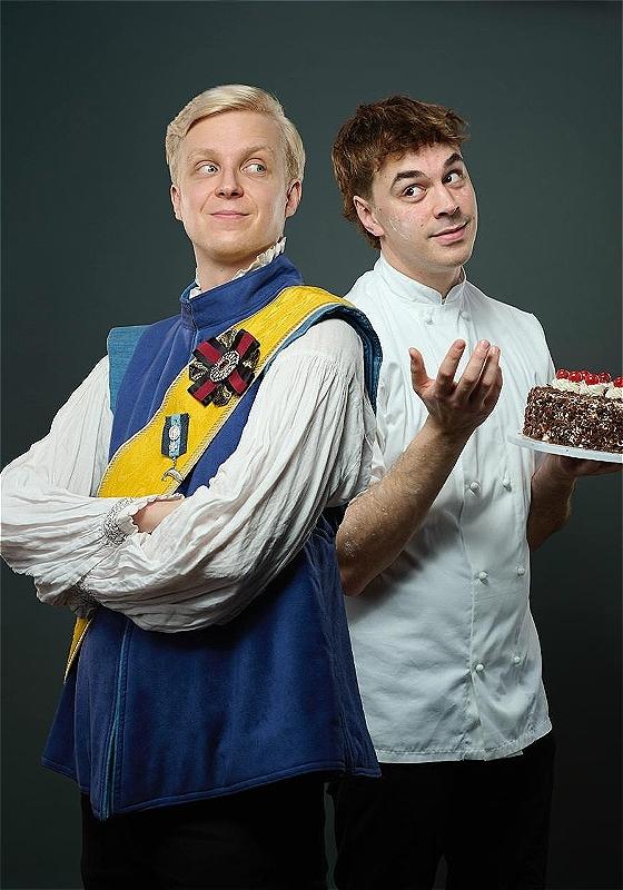 The prince smiling and looking off into the distance whilst the baker looks bewildered holding a black forest gateau