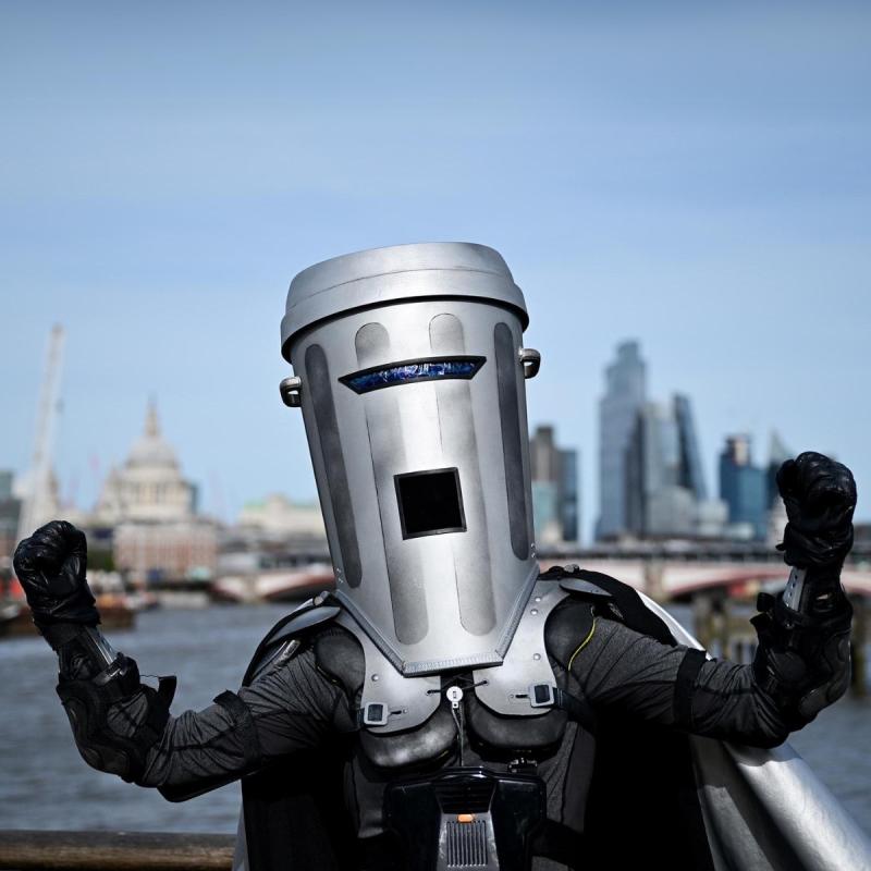 A man in a costume wearing a dustbin helmet, ready for an event or performance.