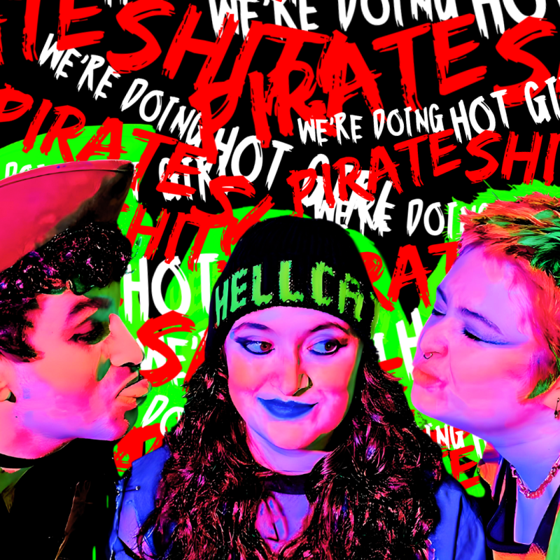 3 performers grin with a thermal filter over the image with the words 'we're doing hot girl pirate shit'