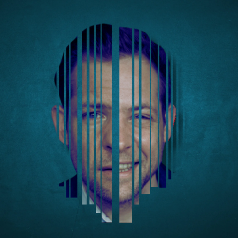 The actor's face, portrayed as if it has gone through a shredder, is in the centre of the image, in front of a murky blue background.