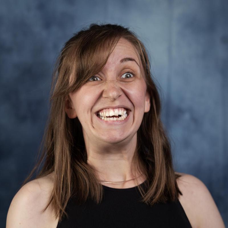 A person smiling with her mouth open