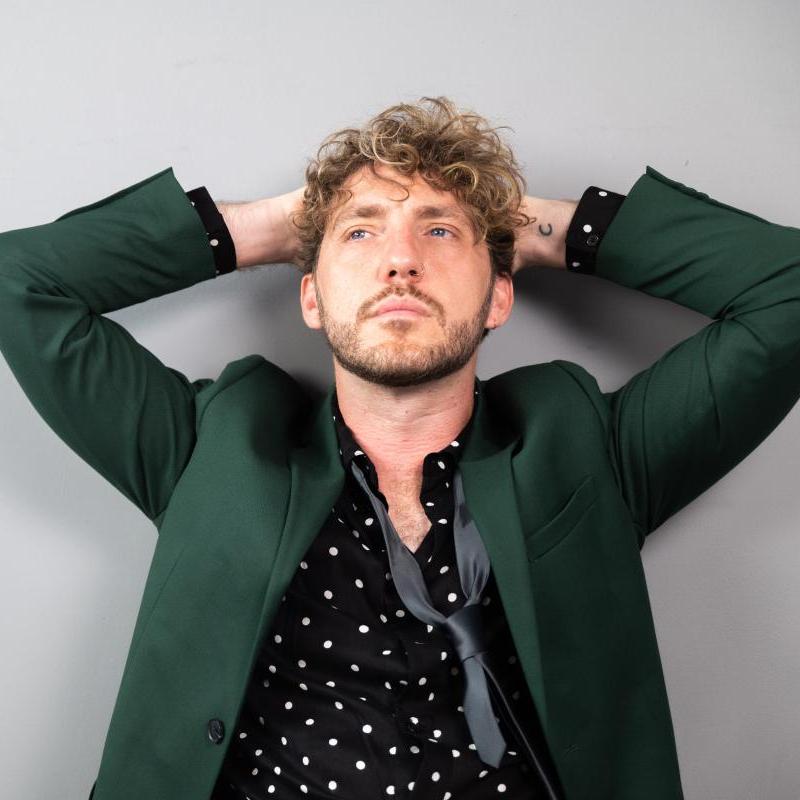 Image of Seann Walsh, comedian, with hands over his head