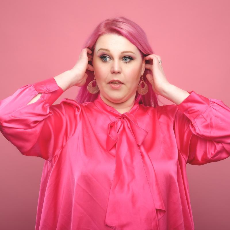 Image of Lindsey Santoro, performer, in front of a pink background