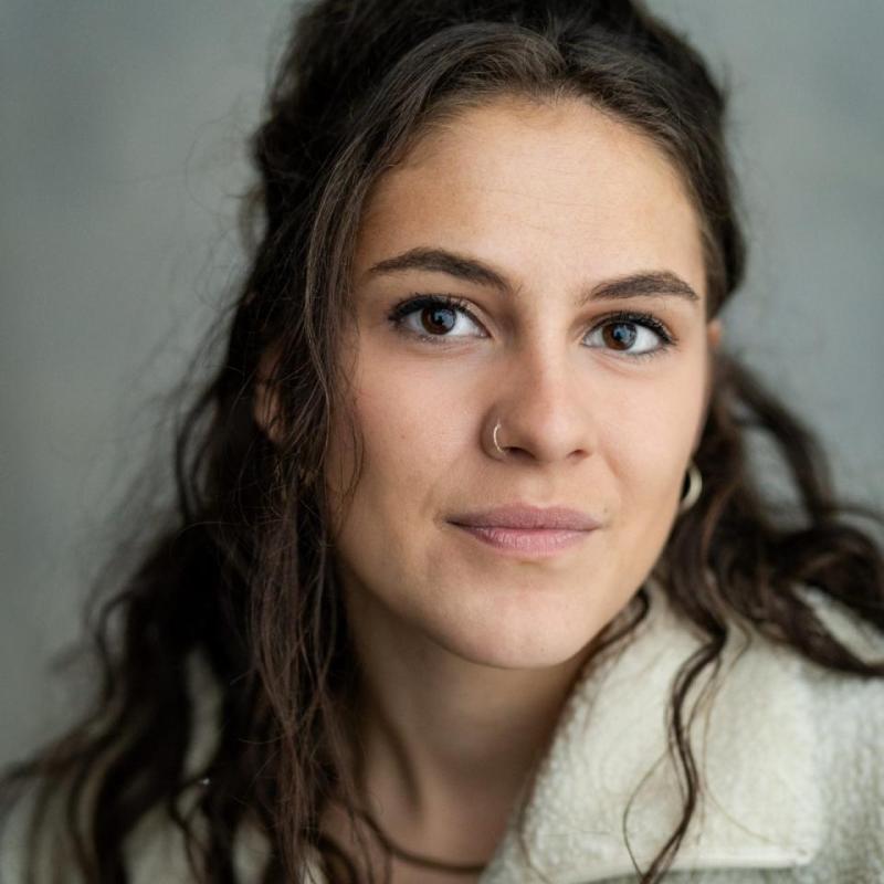 Image of Rosalie Minnitt, performer, in front of a grey background