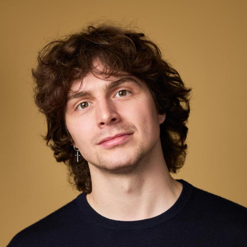 Image of Sam Williams, performer, in front of a beige background