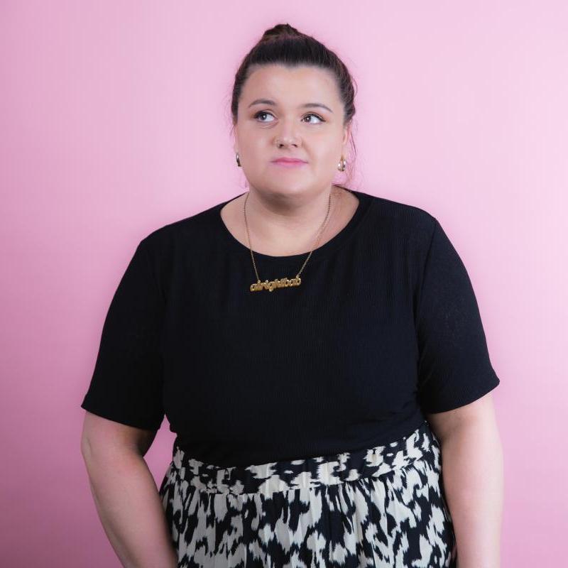 Image of Tal Davies, performer, in front of a pink background