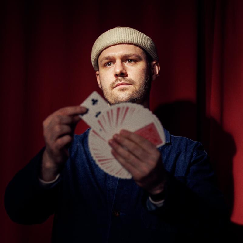 A person holding playing cards